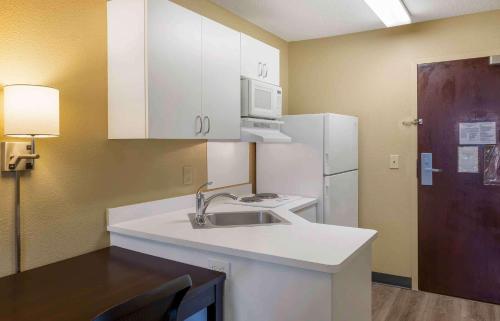 a kitchen with a sink and a white refrigerator at Extended Stay America Suites - Boston - Tewksbury in Tewksbury
