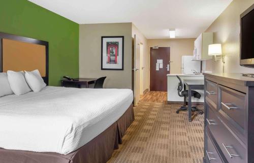 a hotel room with a bed and a kitchen at Extended Stay America Suites - Boston - Westborough - Connector Road in Westborough