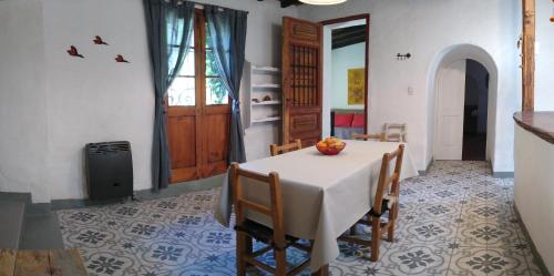 a dining room with a white table and chairs at Casitas del Cerro in Chacras de Coria