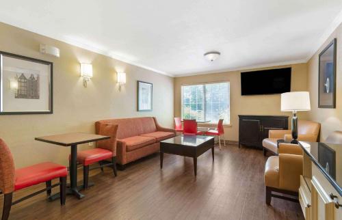 a living room with a couch and a table at Extended Stay America Suites - Hanover - Parsippany in Whippany