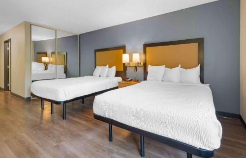 a hotel room with two beds and a mirror at Extended Stay America Suites - Hanover - Parsippany in Whippany