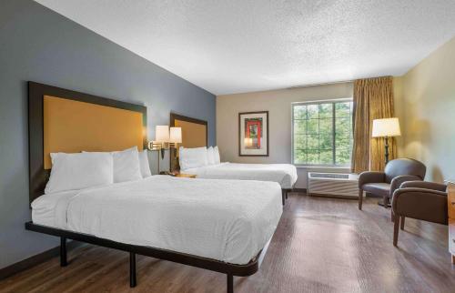 a hotel room with two beds and a window at Extended Stay America Suites - Hanover - Parsippany in Whippany