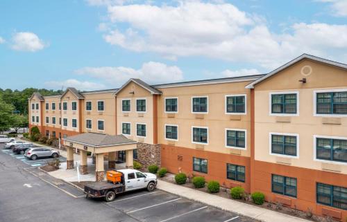 an apartment building with a truck parked in a parking lot at Extended Stay America Suites - Ramsey - Upper Saddle River in Ramsey