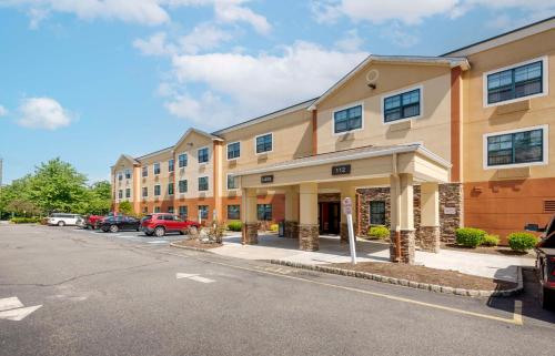 a building with cars parked in a parking lot at Extended Stay America Suites - Ramsey - Upper Saddle River in Ramsey