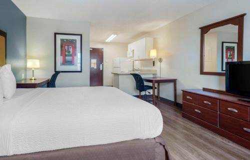 a hotel room with a large bed and a desk at Extended Stay America Suites - Ramsey - Upper Saddle River in Ramsey