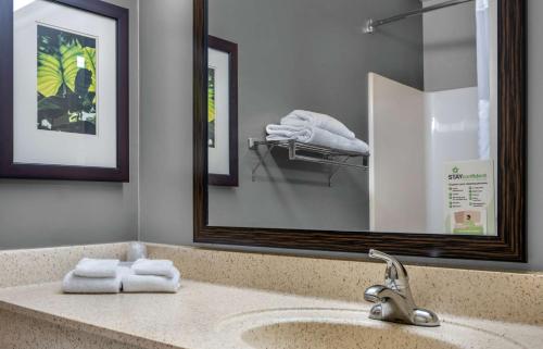 a bathroom with a sink with a mirror and towels at Extended Stay America Suites - Ramsey - Upper Saddle River in Ramsey