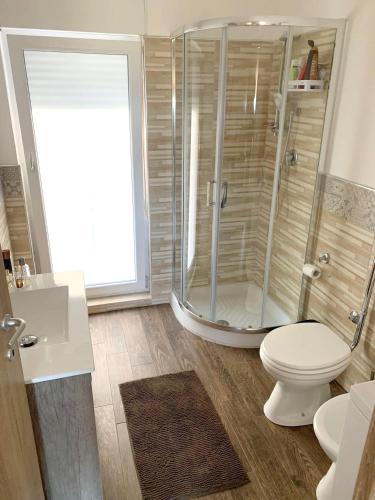 a bathroom with a shower and a toilet at Coastal Apartment Ribera 45 sqm Sea View in Ribera