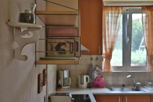 a kitchen with a sink and a microwave at Olive Villa Crete in Rethymno Town