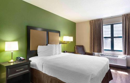 a hotel room with a large bed and a window at Extended Stay America Suites - Nashua - Manchester in Nashua