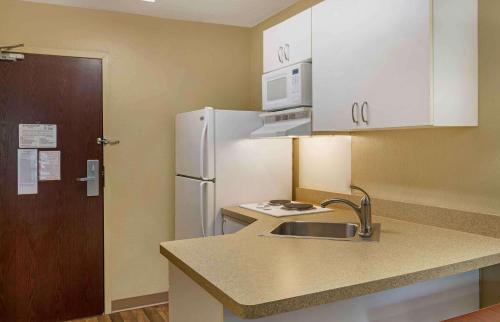 a kitchen with a sink and a white refrigerator at Extended Stay America Suites - Nashua - Manchester in Nashua