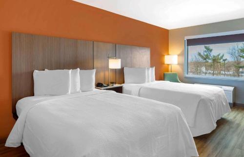 two beds in a hotel room with white sheets at Extended Stay America Premier Suites - Providence - East Providence in East Providence