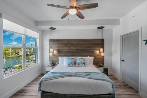 a bedroom with a bed and a ceiling fan at Dolphins Vacation Rental in Merritt Island