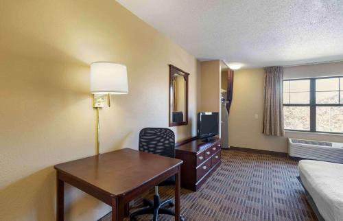 a hotel room with a desk and a bed and a room at Extended Stay America Suites - Frederick - Westview Dr in Frederick