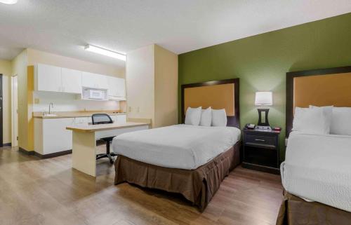 a hotel room with two beds and a kitchen at Extended Stay America Suites - Syracuse - Dewitt in East Syracuse