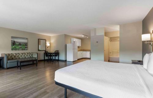 a large room with a white bed and a kitchen at Extended Stay America Suites - Washington, DC - Centreville - Manassas in Centreville