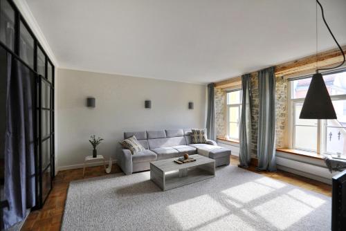 a living room with a couch and a table at Toompea Castle Apartment in Tallinn