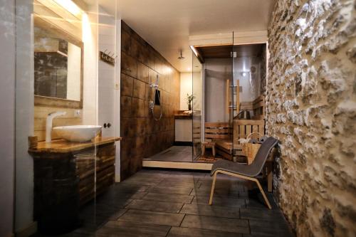 a bathroom with a sink and a chair in it at Toompea Castle Apartment in Tallinn