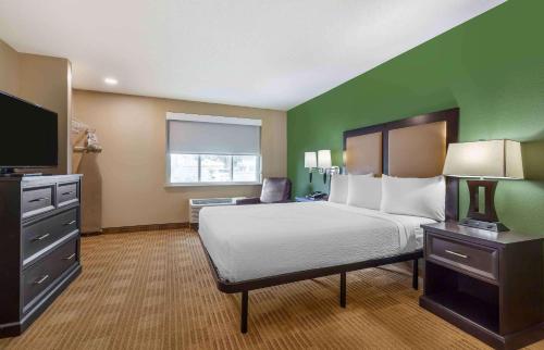 a hotel room with a bed and a flat screen tv at Extended Stay America Suites - Washington, DC - Springfield in Springfield