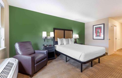 a hotel room with a bed and a chair at Extended Stay America Suites - Washington, DC - Springfield in Springfield