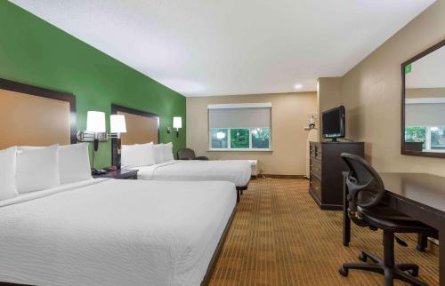 a hotel room with two beds and a desk at Extended Stay America Suites - Washington, DC - Springfield in Springfield