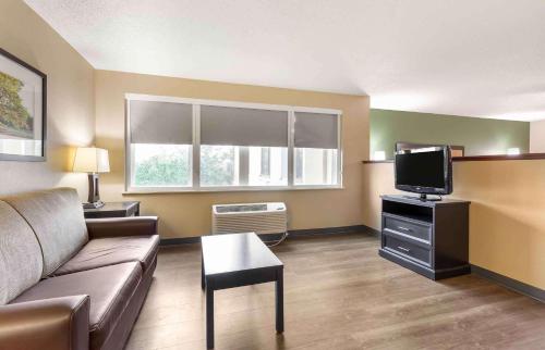 a living room with a couch and a tv at Extended Stay America Suites - Washington, DC - Springfield in Springfield