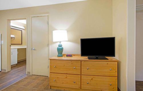 a television on a dresser with a lamp on it at Extended Stay America Select Suites - Washington, DC - Sterling - Dulles in Sterling