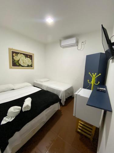 A bed or beds in a room at THEMATIC POUSADA