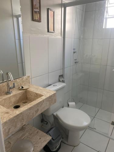 a bathroom with a sink and a toilet and a shower at Novíssimo apartamento térreo in Votorantim