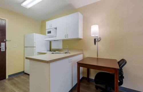 a small kitchen with a desk and a table at Extended Stay America Suites - Washington, DC - Sterling in Sterling