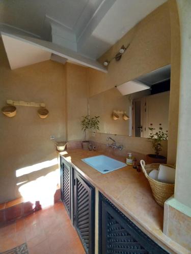 a kitchen with a sink and a counter top at Riad Hostel JAD ZIAD in Marrakech