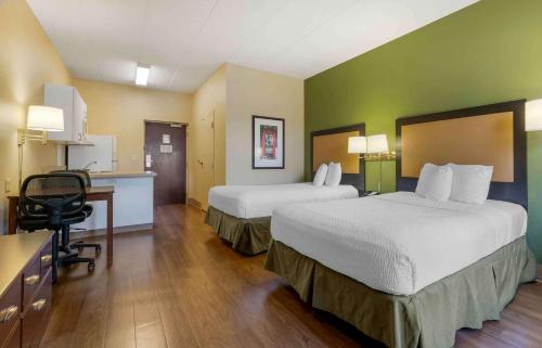 a hotel room with two beds and a desk at Extended Stay America Select Suites - Chicago - Darien in Lemont
