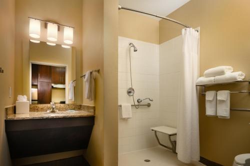 a bathroom with a shower and a toilet and a sink at TownePlace Suites by Marriott Houston Galleria Area in Houston