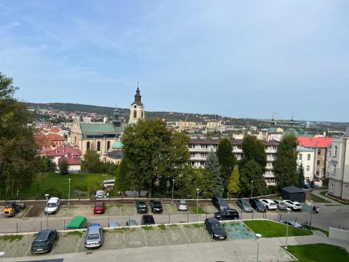 a parking lot with cars parked in a city at Apartament Alexa na Tatarskiej A in Przemyśl