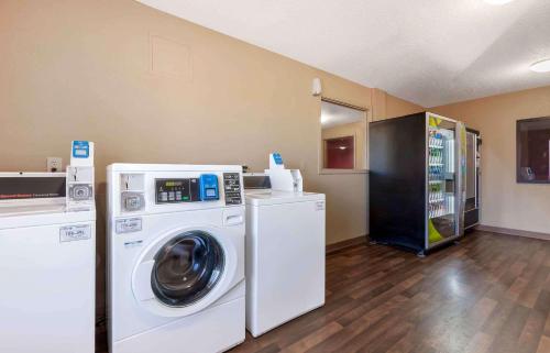 a laundry room with a washing machine and a washer at Extended Stay America Select Suites - Rockford - State Street in Rockford