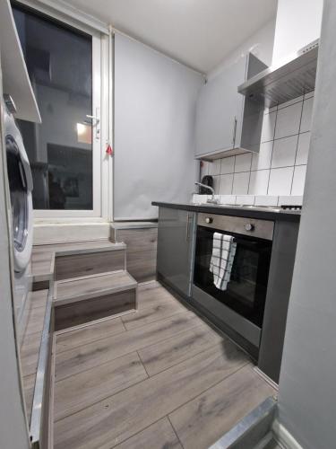 a kitchen with a stove and an oven in it at Cosy Studio Apartment in London in London