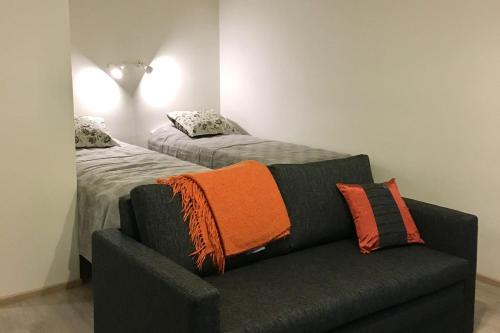 a living room with a couch and a bed at Kotilahti in Rovaniemi