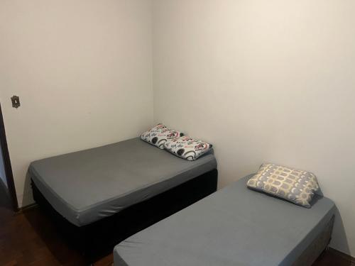 2 aparte bedden in een kleine kamer met: bij Pousada ancora in Uberlândia
