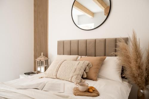 a bedroom with a bed with a mirror on the wall at NALAS domki z widokiem in Rabka