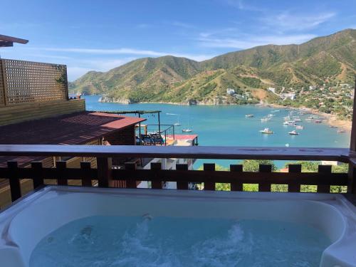 a hot tub on a balcony with a view of a harbor at Cabañas Annapurna in Taganga