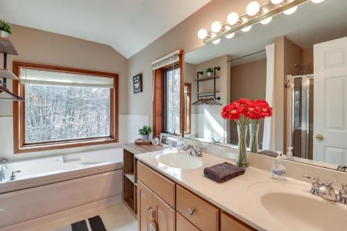 a bathroom with two sinks and a large mirror at Pocono Mountains Retreat with Pool Table and Hot Tub! in Albrightsville
