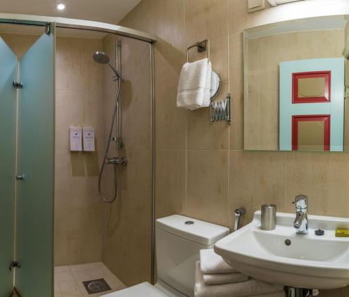 a bathroom with a shower and a toilet and a sink at CRU Hotel in Tallinn