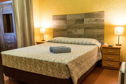 a bedroom with a bed with a blue suitcase on it at Nomada Hostel in Asuncion
