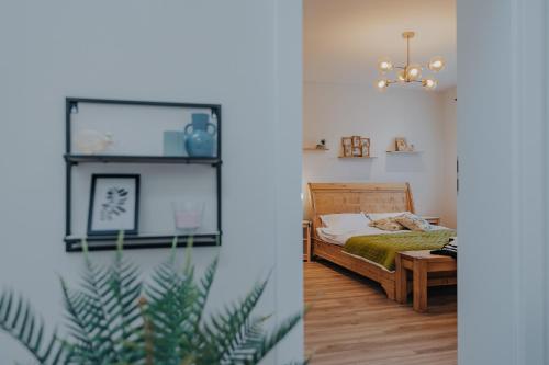a bedroom with a bed and a chandelier at IoanaGuestHouse in Turda
