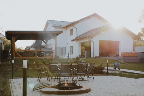a patio with a fire pit in front of a house at IoanaGuestHouse in Turda