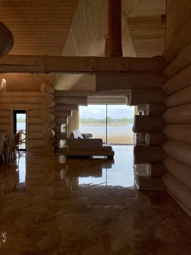 a living room with a couch and a large window at VIP ШАЛЕ ТИША in Shirokaya Greblya