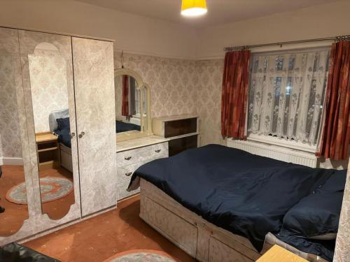 a bedroom with a large bed and a mirror at Sweet dream 2 in London