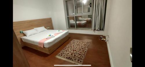 a small bedroom with a bed and a window at Maison 7 New Cairo in Cairo