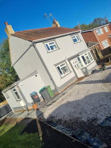 a large white house with a red roof at 3 Bed Detached House & Hot Tub in Wrexham