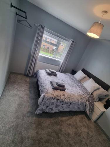 a bedroom with a bed and a window at 3 Bed Detached House & Hot Tub in Wrexham