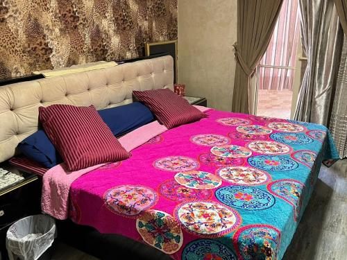 a bed with a pink blanket and plates on it at المقطم,شارع 13,قطعه 331 in Cairo